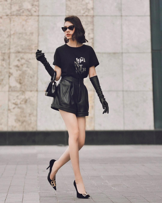 Jolie Nguyễn hóa quý cô thành thị với áo phông, quần shorts tuyền đen, mang giày cao gót Balenciaga cùng màu. Đến túi xách và găng tay cũng được người đẹp lựa chọn item có tông đen đồng điệu.
