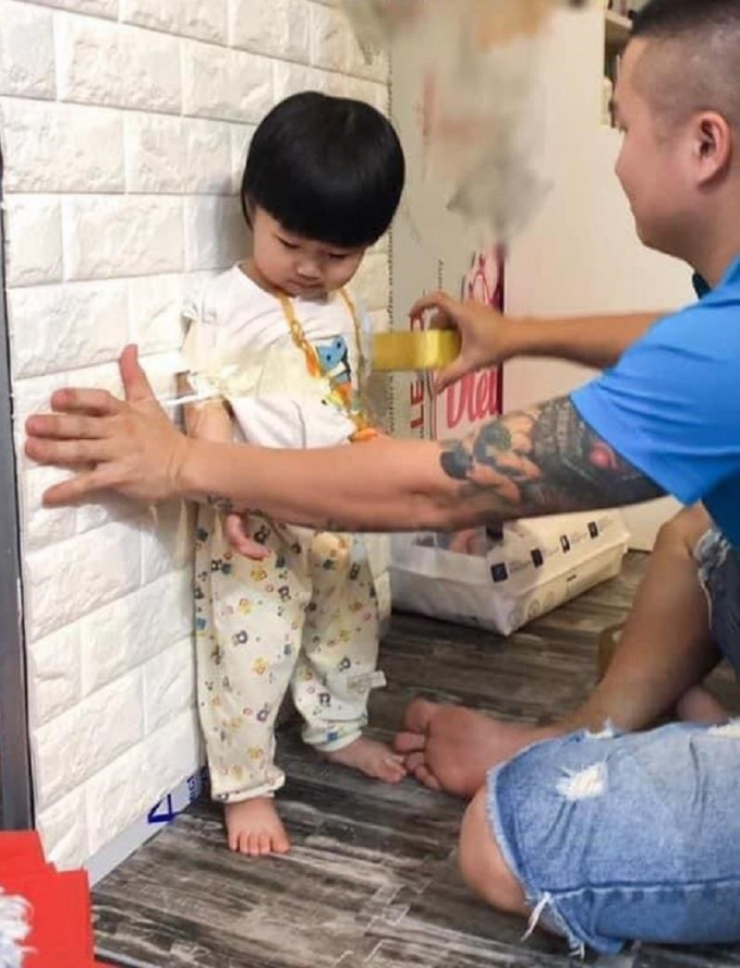 Dán băng dính để trẻ đỡ chạy lung tung quanh nhà là biện pháp nhiều ông bố lựa chọn khi được chị em giao nhiệm vụ trông con. (Ảnh: FB)