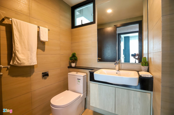 Phòng tắm được bố trí thông thoáng, rộng rãi, lát gạch tường giả gỗ và trang trí bằng cây xanh khiến người sử dụng có cảm giác sinh hoạt trong một không gian trong lành hơn.