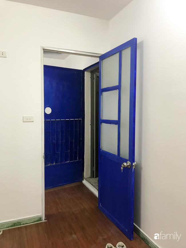 Cửa căn hộ được sơn màu xanh biển.