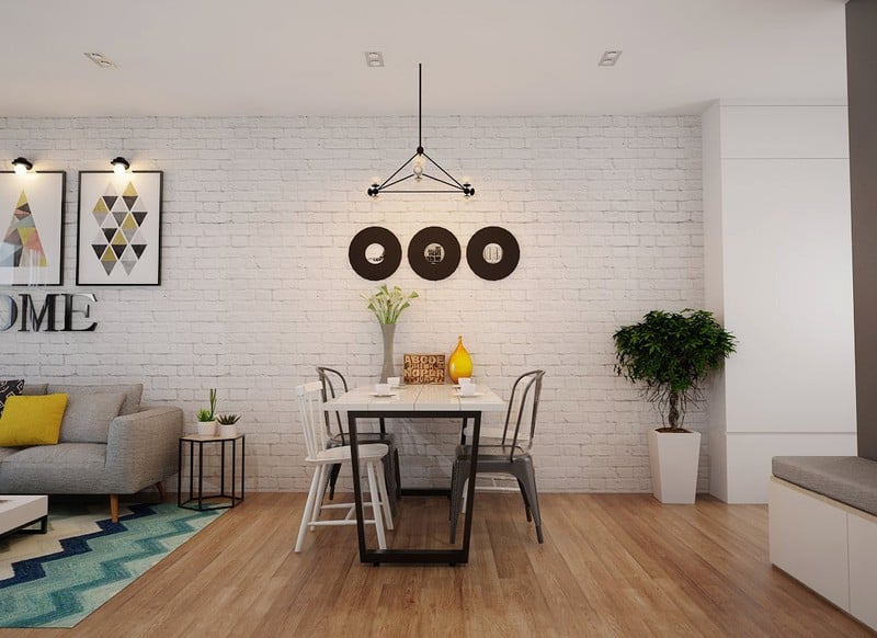 Bức tường gạch thô sơn trắng mang đến hiệu quả thẩm mỹ khá cao cho khu vực bàn ăn.