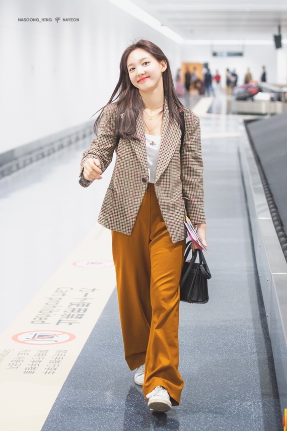  Với set đồ này, Na Yeon đã phối hợp hoàn hảo giữa blazer kẻ màu nâu, áo thun trắng và quần ống rộng màu vàng mù tạt.