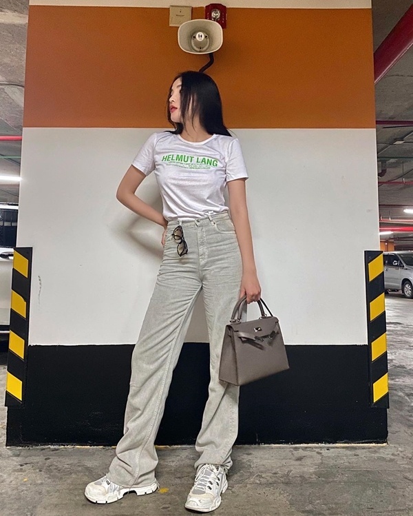   Nàng hậu Kỳ Duyên chọn set đồ phủ tông màu sáng làm chủ đạo đó là áo phông trắng với quần cạp cao ống rộng kèm giày thể thao ton-sur-ton. Cô còn nhấn nhá thêm chiếc túi hàng hiệu đắt giá. 