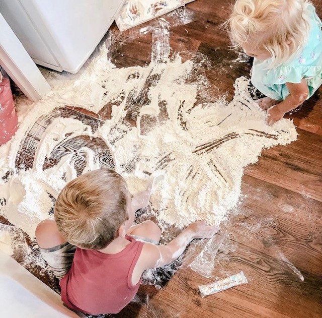  Bé Blaine 4 tuổi và bé Millie 2 tuổi đang cố gắng tạo một sàn nhà từ chất liệu bột mỳ