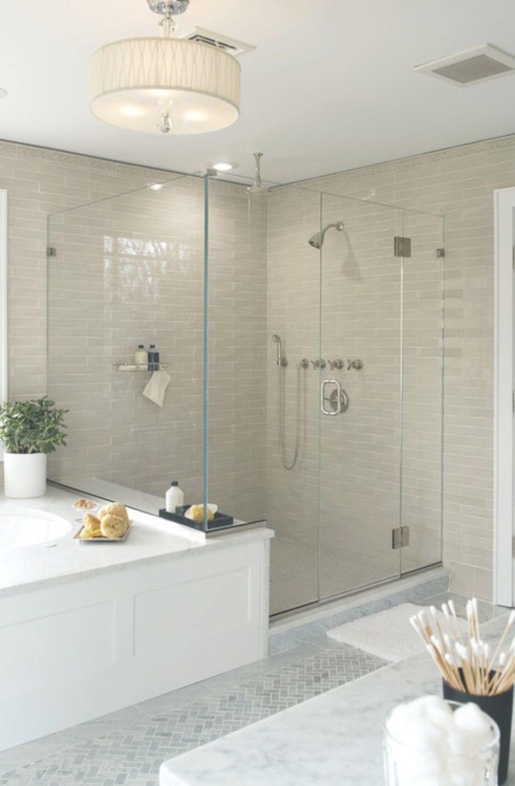  Gạch màu be nhạt trong không gian tắm kết hợp với đèn treo tăng sự ấm áp cho phòng tắm trung tính này.