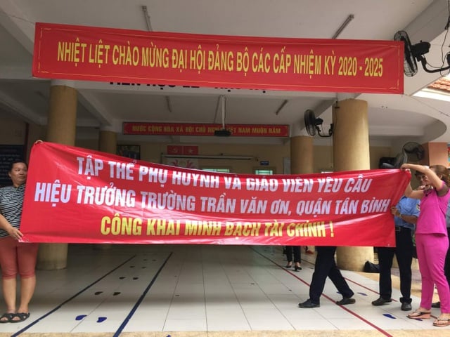  Phụ huynh Trường tiểu học Trần Văn Ơn, Quận Tân Bình, TPHCM cầm băng rôn yêu cầu Hiệu trưởng công khai minh bạch tài chính. (Ảnh: CTV)